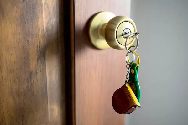 Close Up of Key with Key Chain in Door Lock