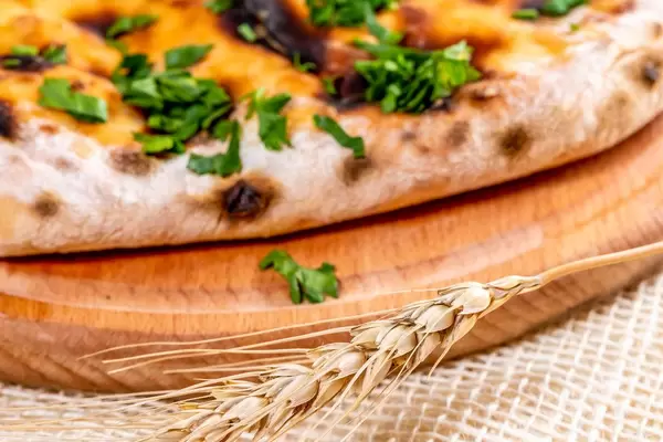 Close-up of khachapuri with greens (Flip 2019)