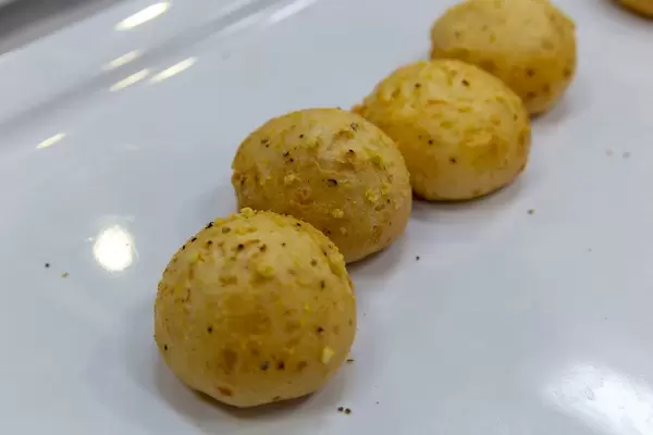 Close-up of lusty cheeseballs with ham at white plate at the BarCamp in Bonn