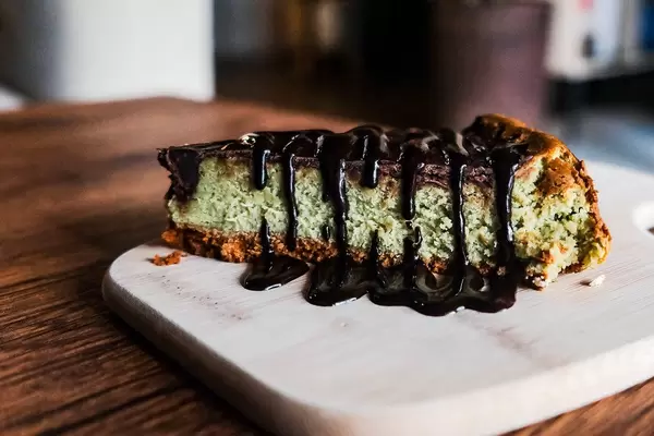 Close up of matcha cheesecake with chocolate fudge (Flip 2019)