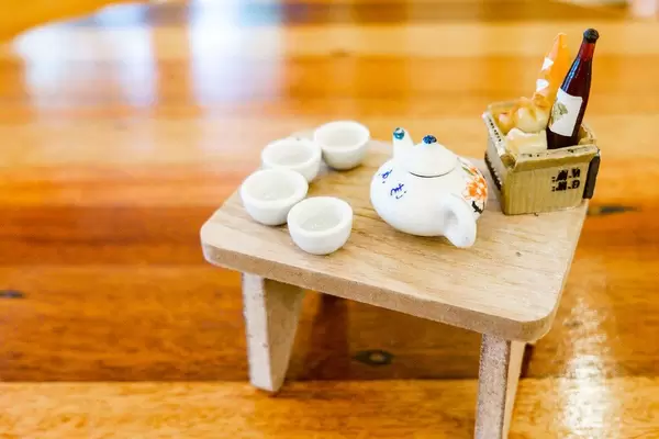 Close up of miniature porcelain set and food basket (Flip 2019)