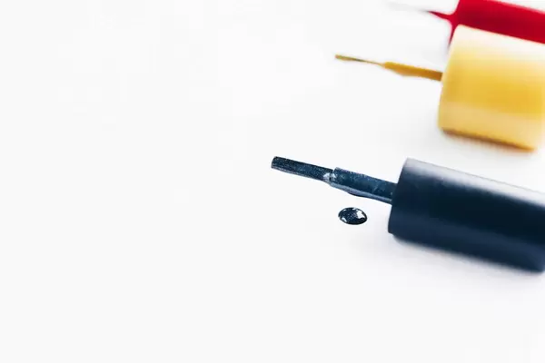 Close up of nail polish spill on white background