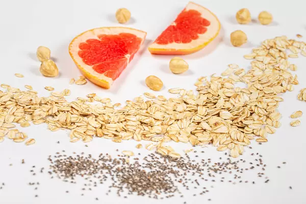 Close-up of oatmeal, chia seeds, hazelnuts and grapefruit pieces
