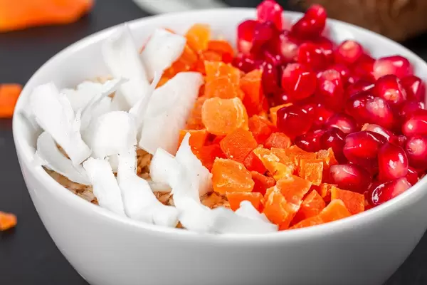 Close- up of oatmeal with coconut, dried apricots and pomegranate (Flip 2020)