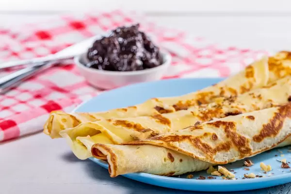 Close-up of pancakes with walnuts and plum jam (Flip 2019)