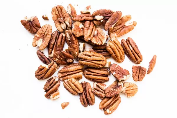 Close up of raw pecan nuts on white background  Flip 2019