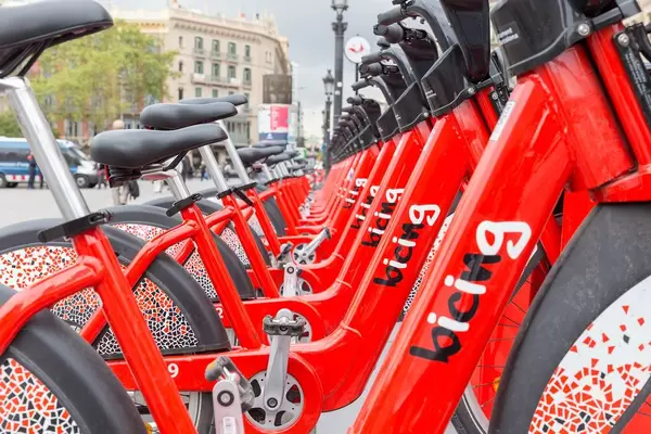 Close-up of red bikes in a row to rent from "bicing" in Barcelona, Spain at Plaça de Catalunya