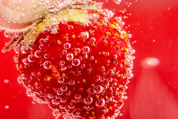 Close-up of ripe strawberries in sparkling water