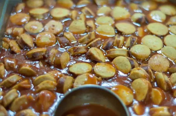 Close-up of sausage slices in sauce