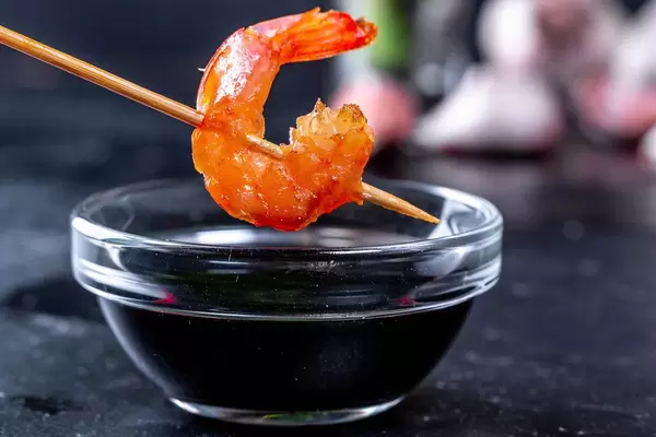 Close-up of shrimp tail and soy sauce