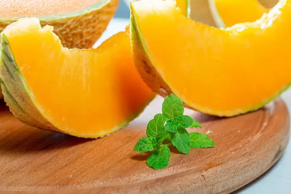 Close-up of slices of fresh melon on the kitchen Board