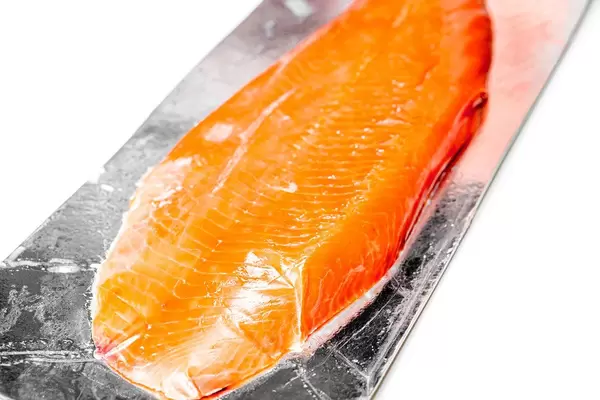 Close-up of smoked red fish fillet on white background (Flip 2020)