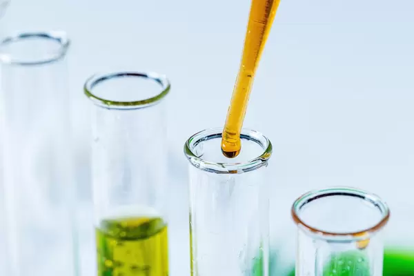 Close-up of solution dripping from a pipette into a laboratory test tube (Flip 2020)