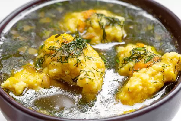 Close - up of soup with dumplings and dill