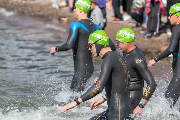 Close-up of the swimmers start for the Ironman 70.3 on the coast of Lahti, in Lake Vesijärvi in the south of Finland