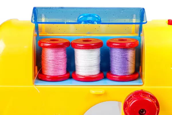 Close up of three spools of thread in a toy sewing machine (Flip 2020)