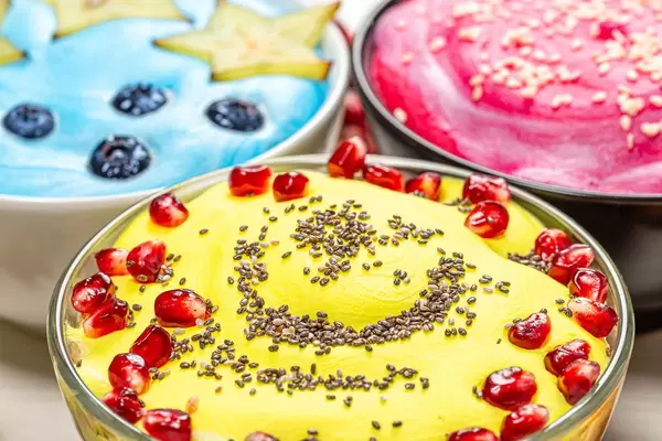 Close up of three versions of oatmeal with fruit and seeds (Flip 2019)