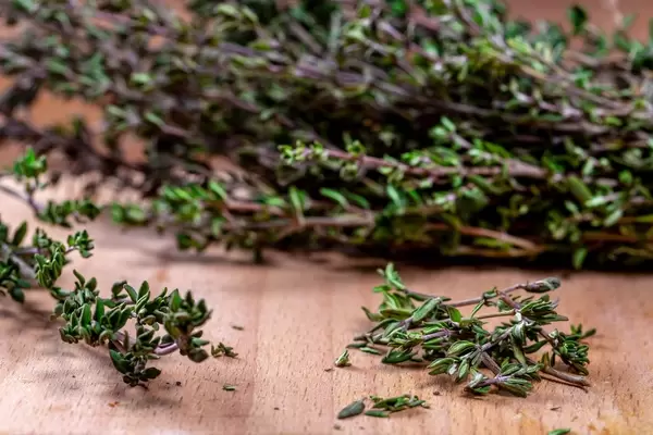 Close-up of thyme grass on wooden background