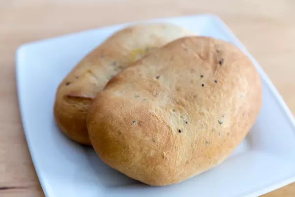 Close-up of two bread buns on a white plate