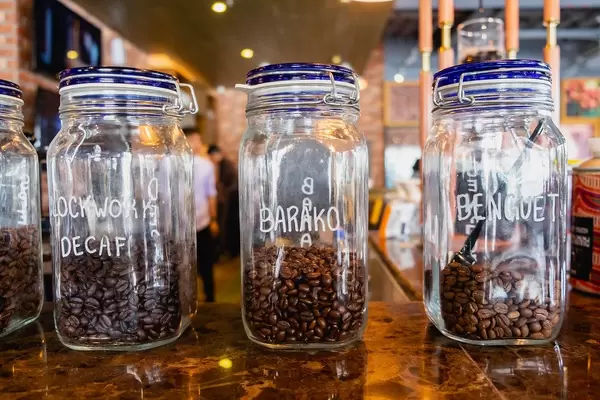 Close up of various coffee beans in sealed jars