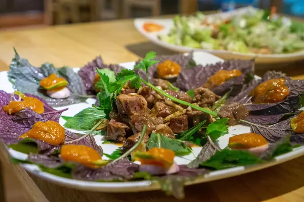 Close Up of Vietnamese Wrap and Roll Dish with Stir Fried Beef, Herbs and Kumquat Sauce
