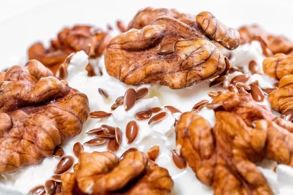 Close-up of walnuts and flax seeds on cottage cheese dessert (Flip 2019)