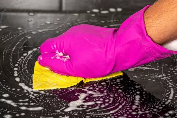 Close-up of washing the electric hob