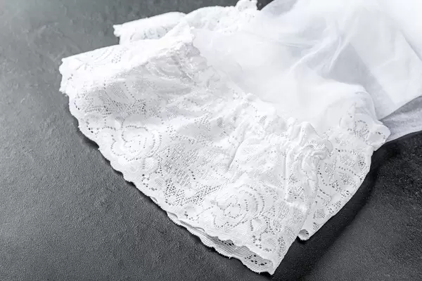 Close-up of white women's stockings on a black background (Flip 2020)