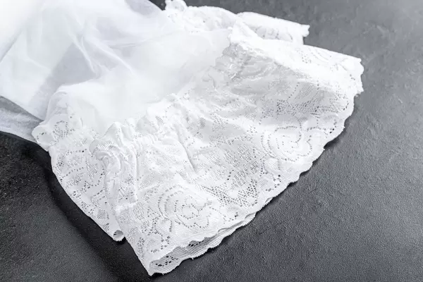 Close-up of white women's stockings on a black background