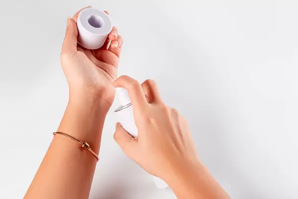 Close up of woman hands spraying perfume