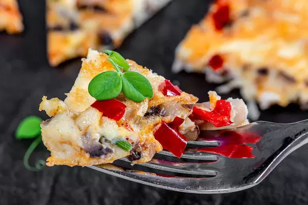 Close-up omelette with vegetables on a fork