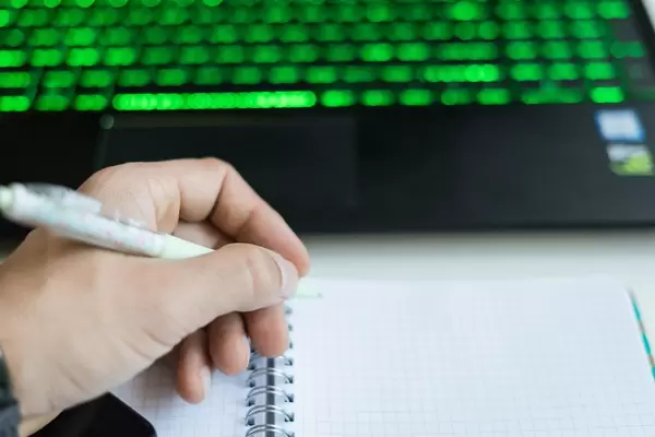 Close up on a Man's Hand Writing in the Spiral notebook