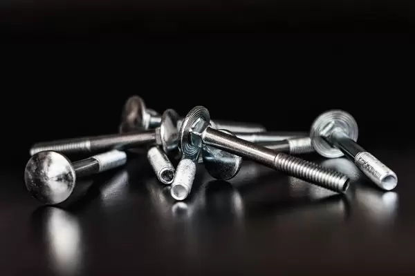 Close up on a Pile of Bolts on the Black Background