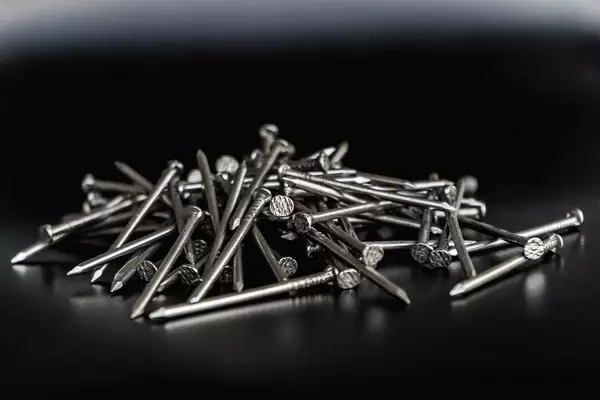 Close up on a Pile of Nails on the Black Background