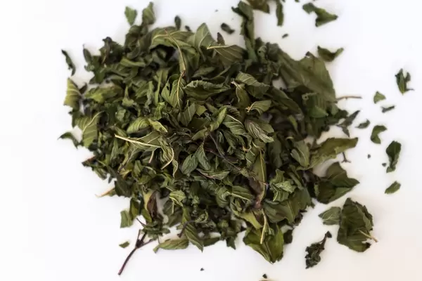 Close Up on dried peppermint leaves on white background