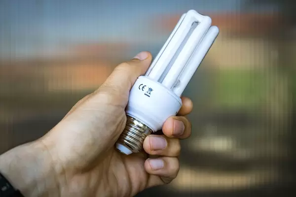 Close Up on the Compact Fluorescent Lamp in the Hand