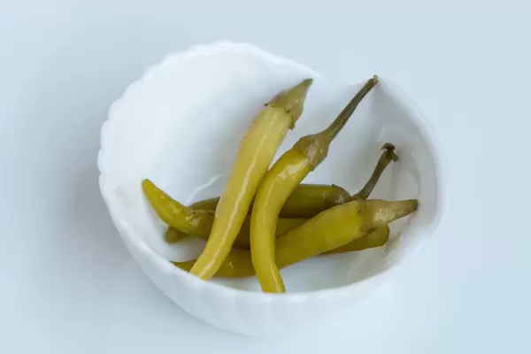 Close Up on the Green Chilly Peppers in the White Bowl