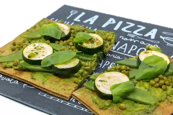 Close Up on the green Lizza - healthy vegan pizza with crust made from chia and flaxseeds