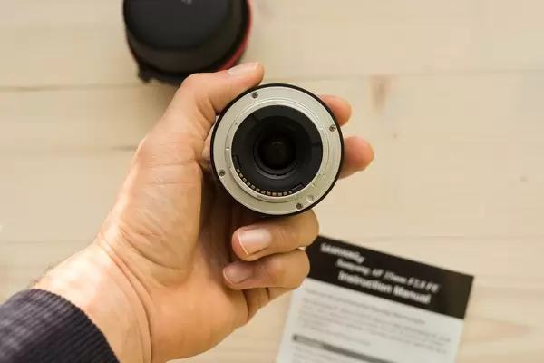 Close Up on the Hand Holding a Camera Lens