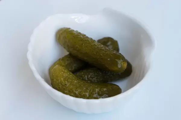 Close Up on the Pickles in the White Bowl