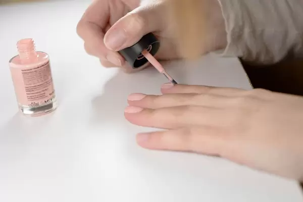 Close Up on Woman's Hands While Painting Nails