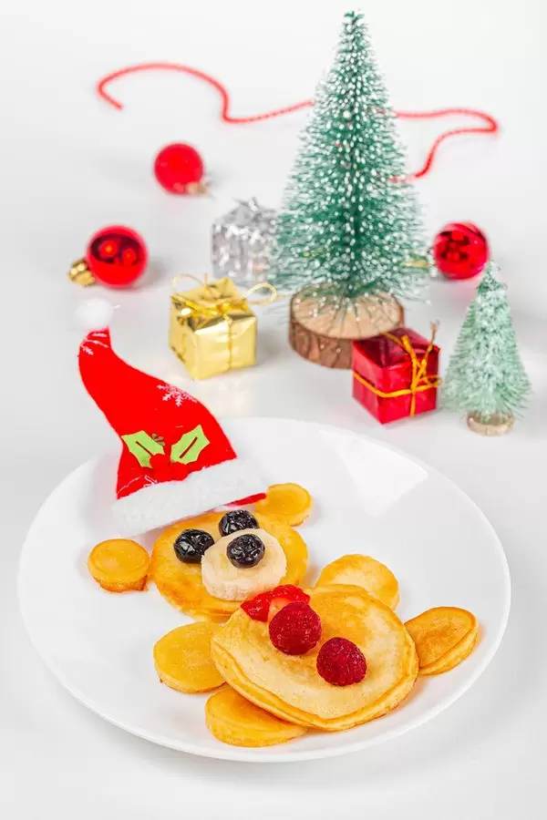 Close-up, pancakes bear with berries, new year gifts and christmas tree