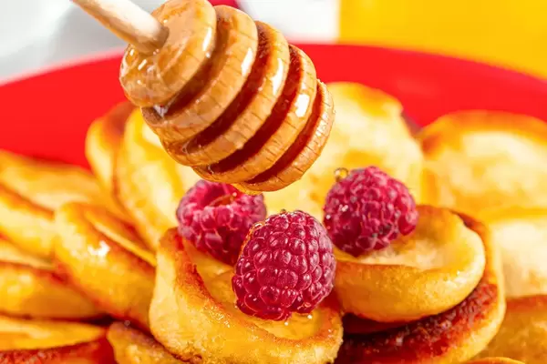 Close-up, pancakes pour with honey