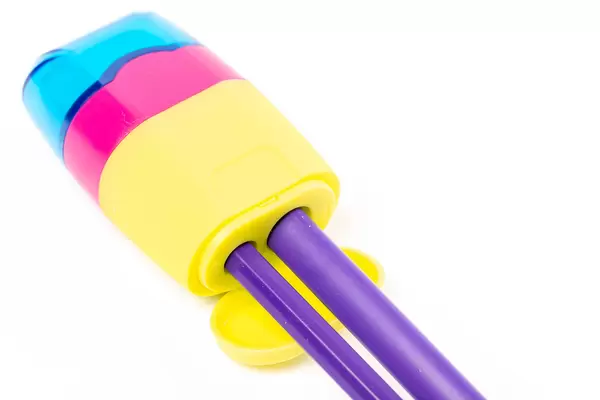 Close-up, pencil sharpener with thick and thin pencils