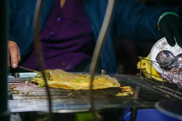 Close Up Photo of a Woman making Vietnamese Grilled Rice Paper