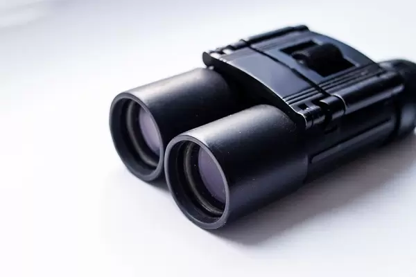 Close Up Photo of Black Binoculars on White Background