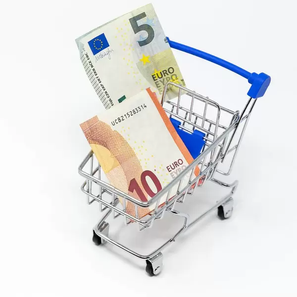 Close Up Photo of Euro Banknotes in a Supermarket Cart on White Background