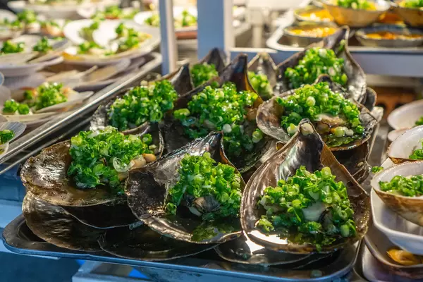 Close Up Photo of Grilled Horn Scallops with Spring Onions on a Street Food Cart at the Night Market in Phu Quoc, Vietnam