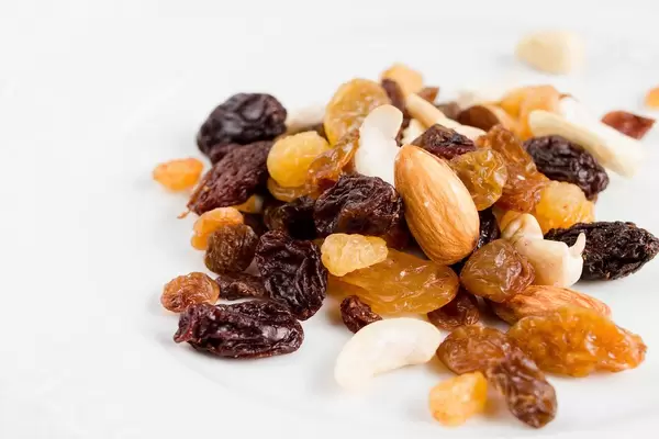Close Up Photo of Nuts and Raisins on white Background