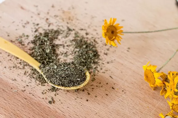 Close Up Photo of on Wooden Spoon with Dried Oregano Spice on Wooden Table